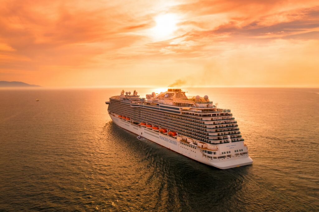 Luxury cruise ship sailing at sunset